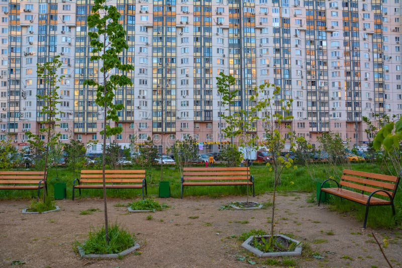 Benches and young trees in the background of a residential building. Copy space. Krasnogorsk, Moscow region, Russia - May 17, 2020 stock photos